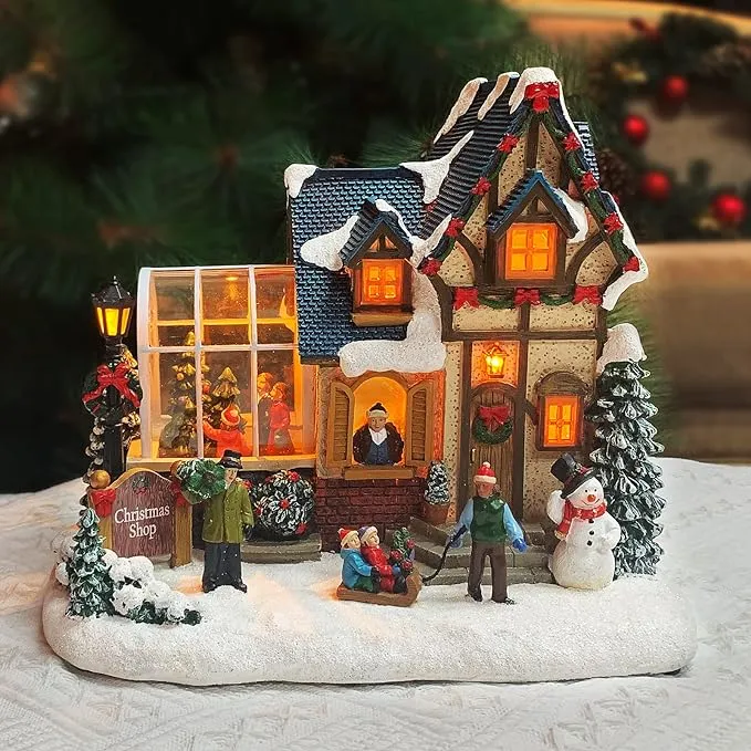 MOMENTS IN TIME Christmas Village Building, Christmas Shop with Snowman, LED Lights and Music - Battery Operated (not Included) Adapter Included (8.5" H x 9.8" W x 6.9" D)